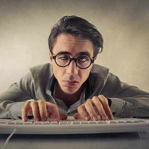 man with tired eyes at computer