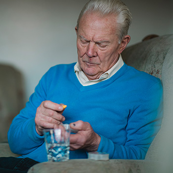 Senior taking CoQ10 supplement