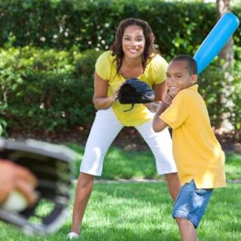 family playing in green space