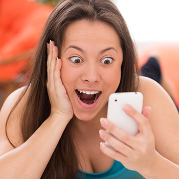 woman misusing her vision on a cell phone in the sun