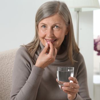 senior takes vitamins and nutrients for eyes